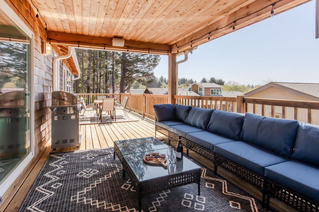 Haystack Hideaway - porch with seating area, table and dinging space Vacation Rental in Cannon Beach, Anchor's Retreat porch